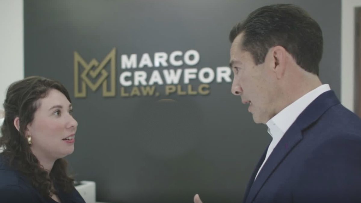 Attorney Marco Crawford speaking with a client in the Marco Crawford Law office in San Antonio
